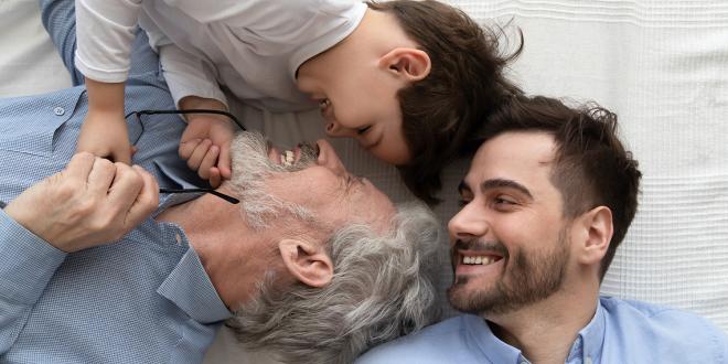 three generations of men laughing together