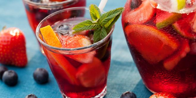 a sparkling punch mocktail with cut fruit and garnish