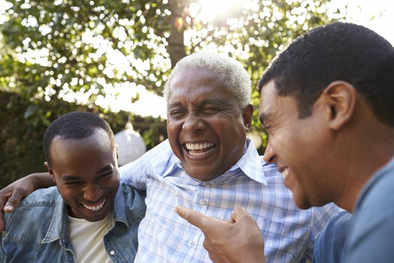 a father laughing with his adult sons