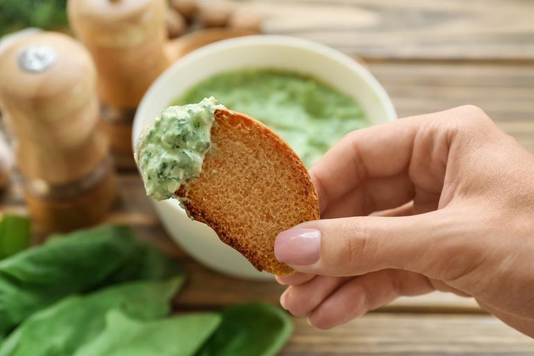 toasted bread dipped into spinach-cheese dip