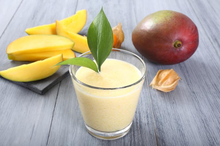 a glass of fresh mango smoothie