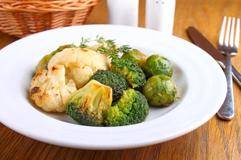 a plate of roasted cauliflower and brussels sprouts